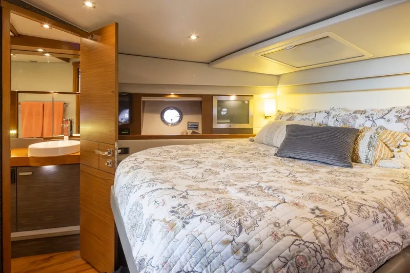 Slide: The Image of Luxurious 2019 Tiara Yachts C44 Coupe bedroom with elegant bedding and modern design. - 18