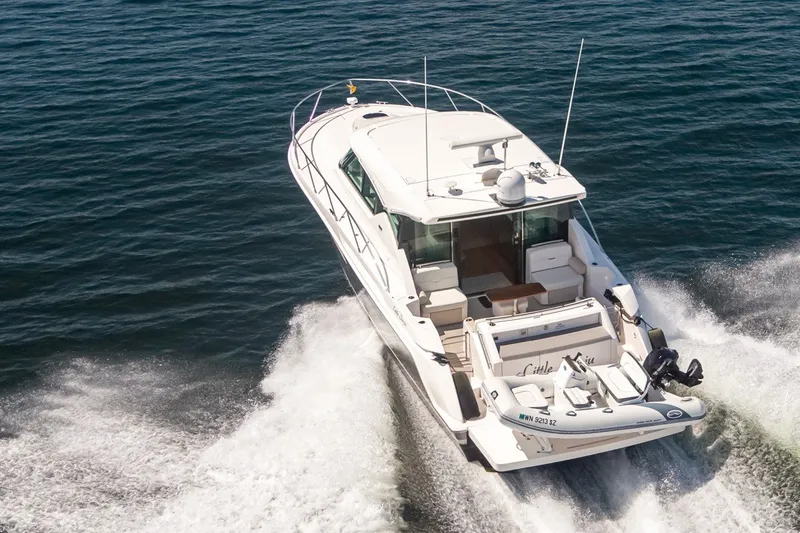 Slide: The Image of 2019 Tiara Yachts C44 Coupe cruising on open water, rear view. - 45