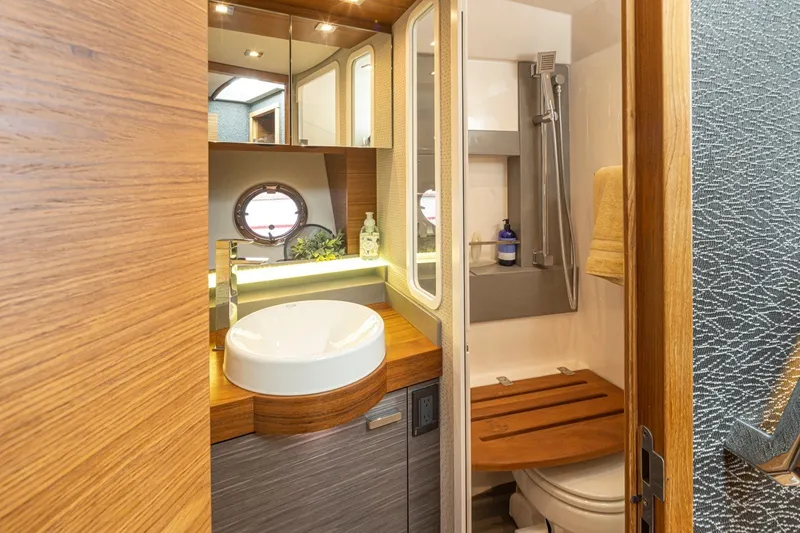 Slide: The Image of Luxurious bathroom in 2019 Tiara Yachts C44 Coupe with modern fixtures and wooden accents. - 23