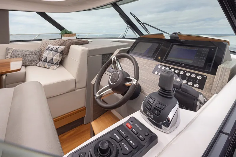 Slide: The Image of Luxurious 2019 Tiara Yachts C44 Coupe helm with modern controls and plush seating. - 11