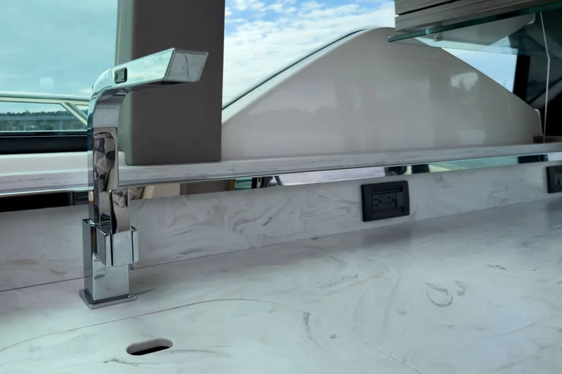 Slide: The Image of Modern kitchen sink area on 2019 Tiara Yachts C44 Coupe with sleek faucet design. - 15