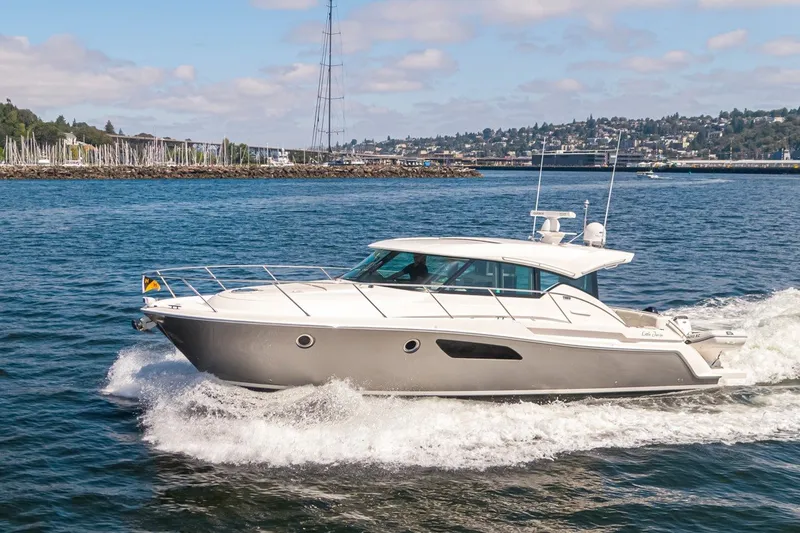 Slide: The Image of 2019 Tiara Yachts C44 Coupe cruising on a scenic waterway. - 42