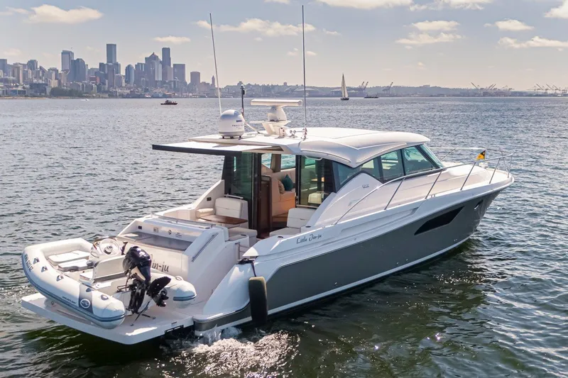 Slide: The Image of 2019 Tiara Yachts C44 Coupe cruising near city skyline on a sunny day. - 38