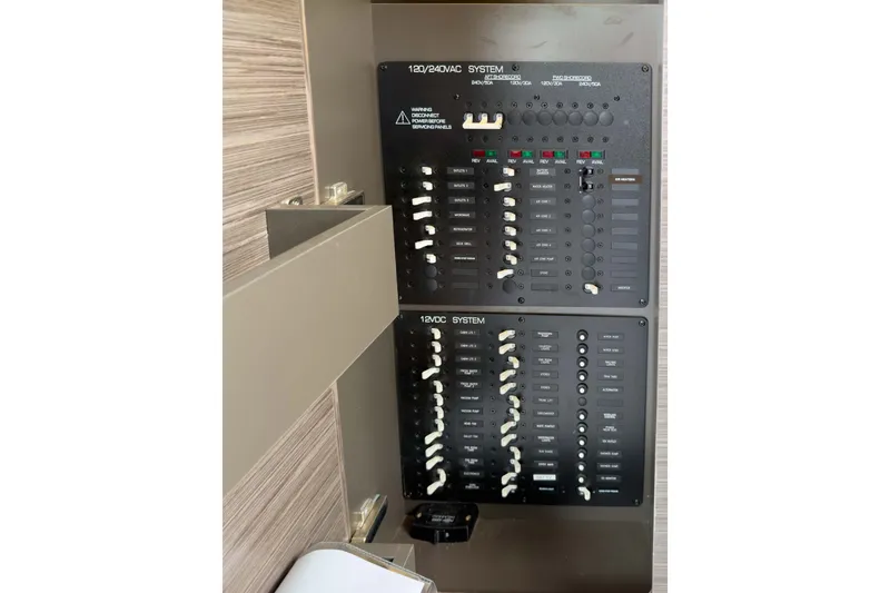 Slide: The Image of Electrical panel on a 2019 Tiara Yachts C44 Coupe, showcasing 120/240VAC and 12VDC systems. - 16