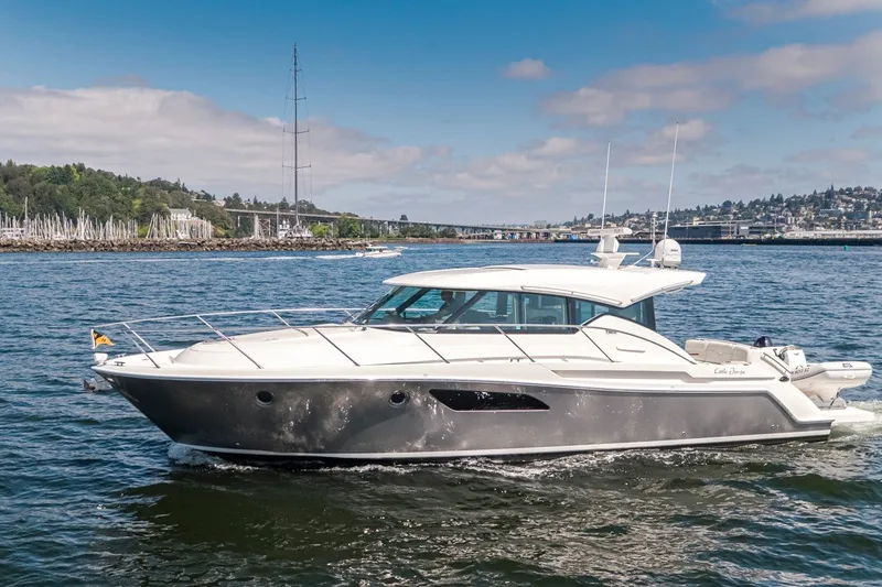 Slide: The Image of 2019 Tiara Yachts C44 Coupe cruising on a scenic waterway. - 2