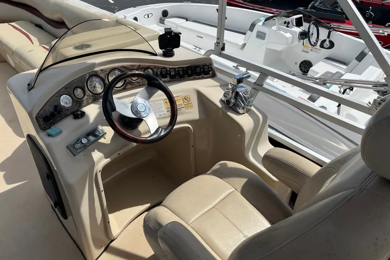 Slide: The Image of Cockpit of 2014 Bentley Pontoons Elite 250 with steering wheel and control panel. - 7