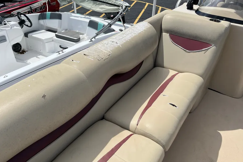 Slide: The Image of 2014 Bentley Pontoons Elite 250 with worn beige and maroon seating in need of repair. - 11