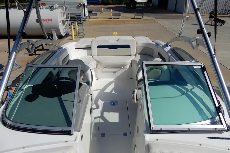 Slide: The Image of 2017 Chaparral 246 SSi boat interior with white seating and open windshield. - 32