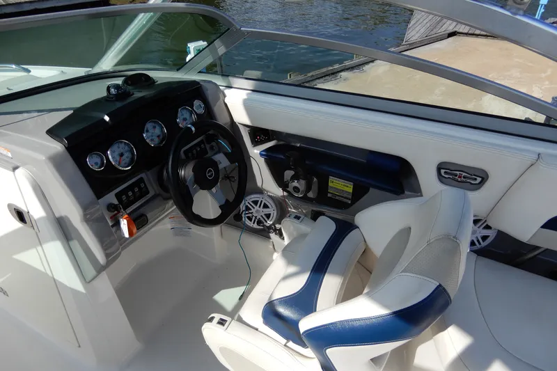 Slide: The Image of 2017 Chaparral 246 SSi boat cockpit with steering wheel and dashboard controls. - 21
