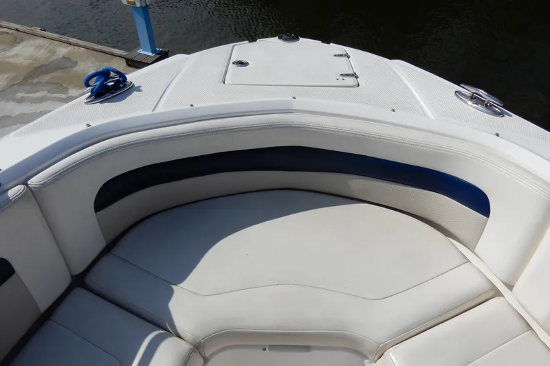 Slide: The Image of 2017 Chaparral 246 SSi boat interior with white and blue seating at dockside. - 26