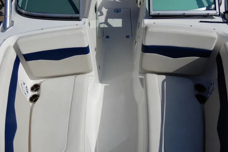 Slide: The Image of Interior view of a 2017 Chaparral 246 SSi boat, featuring white and blue seating. - 31