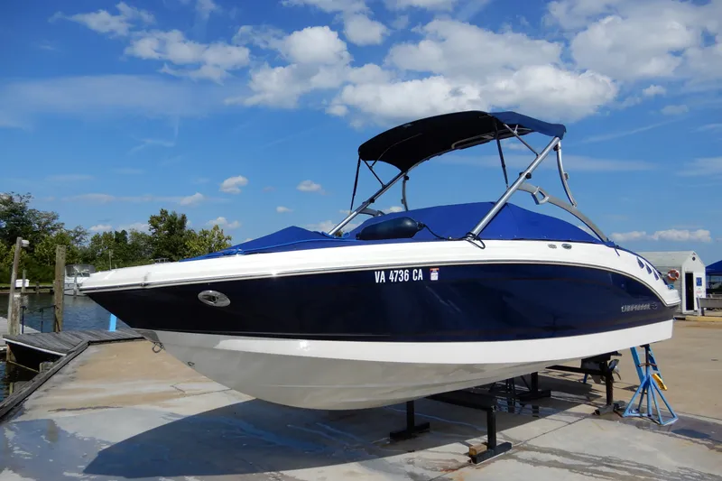 The Image of 2017 Chaparral 246 SSi boat on a lift under a clear blue sky. - 0