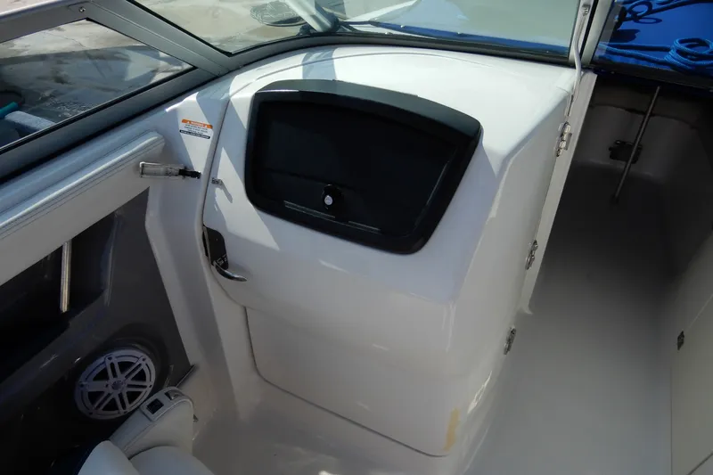 Slide: The Image of 2017 Chaparral 246 SSi boat interior, featuring a sleek dashboard and storage compartment. - 16