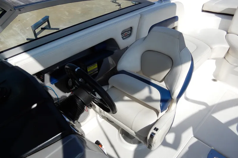 Slide: The Image of 2017 Chaparral 246 SSi boat interior with steering wheel and comfortable seating. - 22