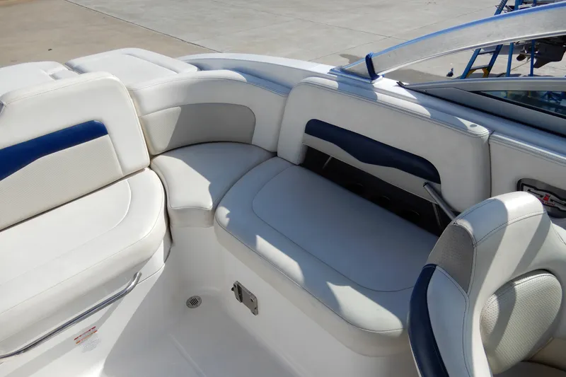 Slide: The Image of 2017 Chaparral 246 SSi boat interior with white and blue seating arrangement. - 14