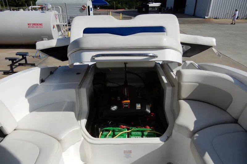 Slide: The Image of 2017 Chaparral 246 SSi boat engine compartment with seating and storage area. - 33
