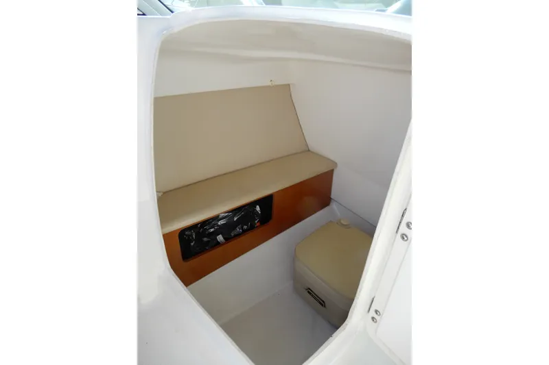 Slide: The Image of 2017 Chaparral 246 SSi boat interior cabin with beige seating and storage. - 19