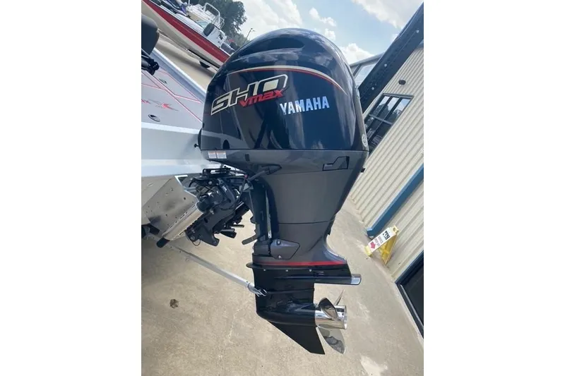 Slide: The Image of Yamaha SHO Max outboard motor on 2026 Xpress H20 Crappie boat, parked outdoors. - 7