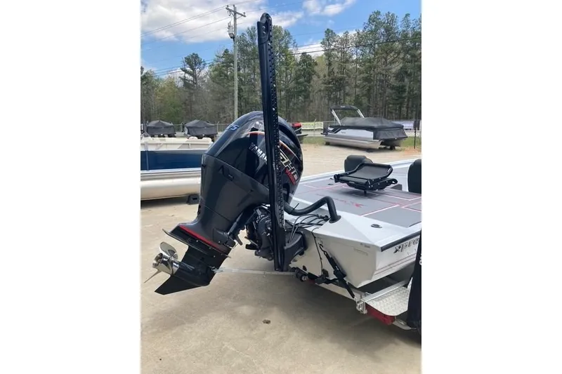 Slide: The Image of 2026 Xpress H20 Crappie boat with powerful outboard motor, parked outdoors. - 8