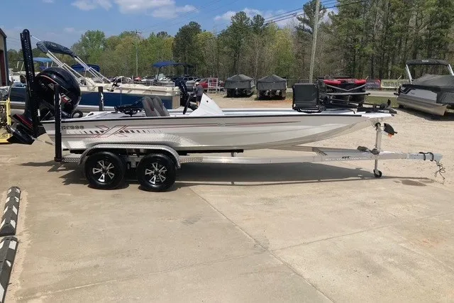 The Image of 2026 Xpress H20 Crappie boat on trailer, parked outdoors with other boats. - 1