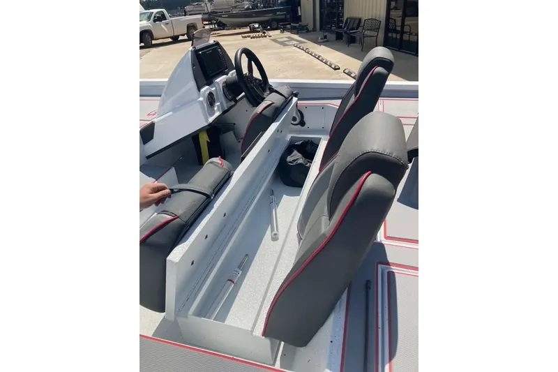 Slide: The Image of 2026 Xpress H20 Crappie boat interior with gray seats and steering console. - 10