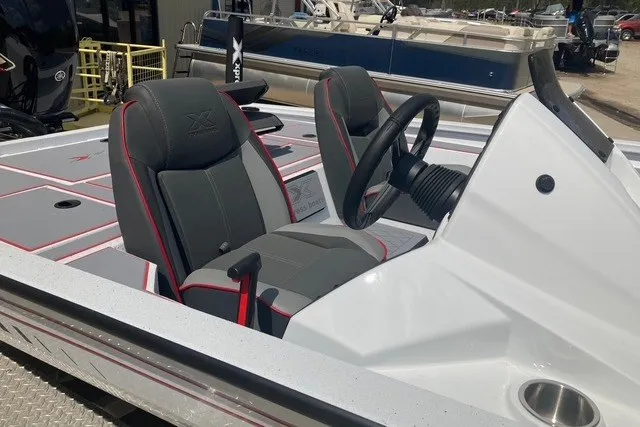 Slide: The Image of 2026 Xpress H20 Crappie boat interior with dual seats and steering wheel. - 11