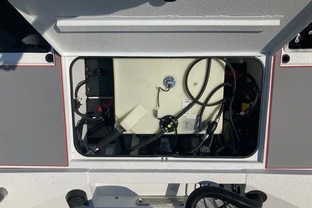 Slide: The Image of Open compartment of 2026 Xpress H20 Crappie boat showing internal components and wiring. - 17