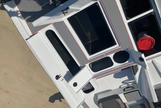 Slide: The Image of 2026 Xpress H20 Crappie boat interior with open storage compartments and seating. - 18