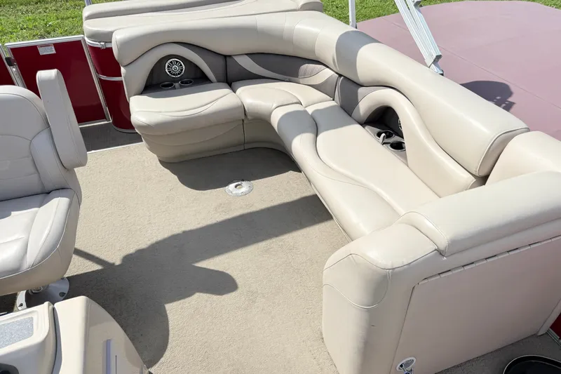 Slide: The Image of 2016 Sylvan Mirage 8520 boat interior with beige seating and cup holders. - 10