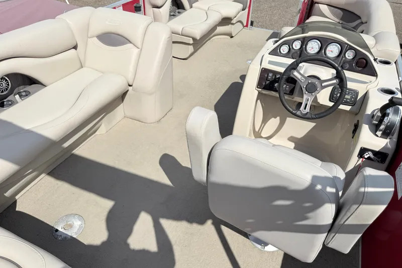 Slide: The Image of Interior of a 2016 Sylvan Mirage 8520 pontoon boat with beige seating and steering console. - 17