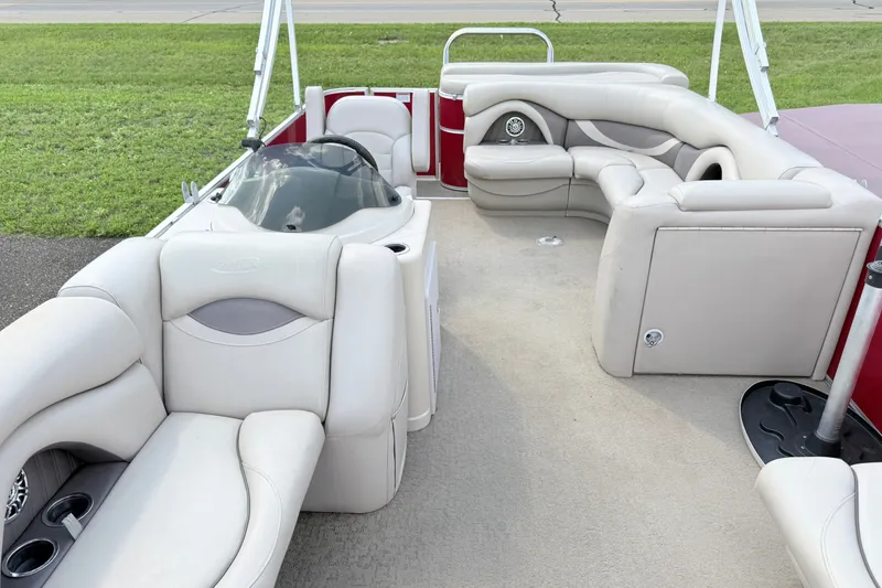 Slide: The Image of 2016 Sylvan Mirage 8520 pontoon boat interior with plush seating and helm. - 6