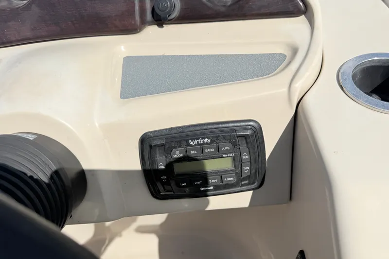 Slide: The Image of Dashboard of a 2016 Sylvan Mirage 8520 boat featuring an Infinity stereo system. - 14