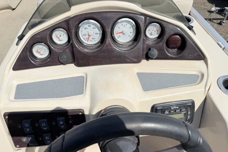 Slide: The Image of Dashboard of a 2016 Sylvan Mirage 8520 boat with gauges and controls. - 12