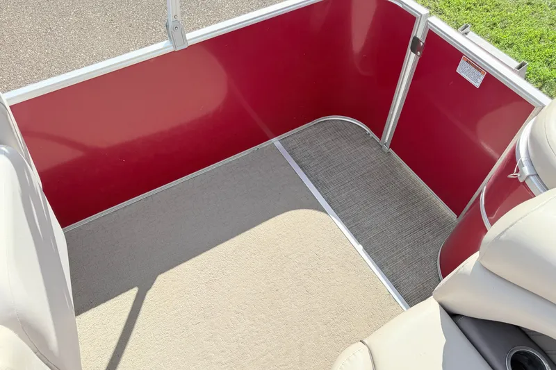 Slide: The Image of Interior of a 2016 Sylvan Mirage 8520 pontoon boat with red paneling and beige seating. - 16