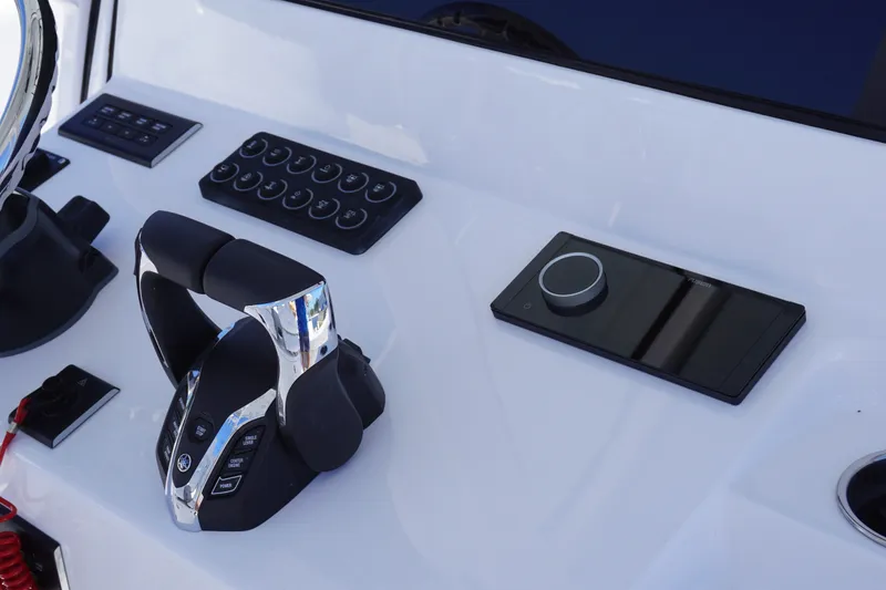 Slide: The Image of Control panel of 2027 Sportsman Open 282 Center Console boat with modern throttle and switches. - 20