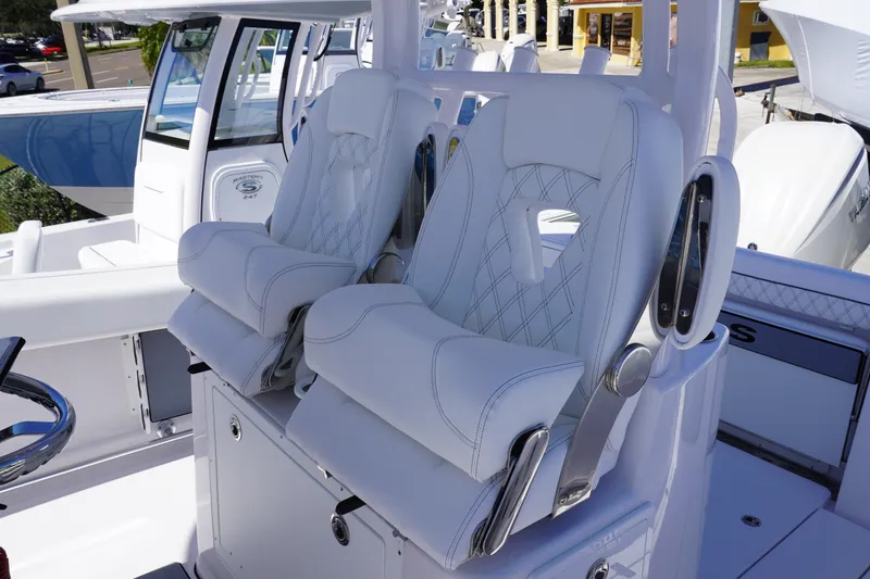 Slide: The Image of Luxurious seating on 2027 Sportsman Open 282 Center Console boat, featuring sleek white upholstery. - 22