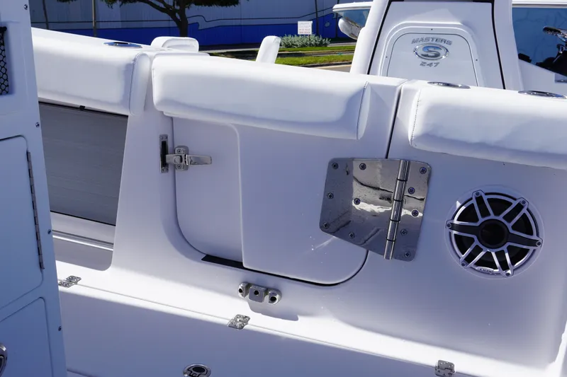 Slide: The Image of 2027 Sportsman Open 282 Center Console boat interior with speaker and hinge detail. - 14