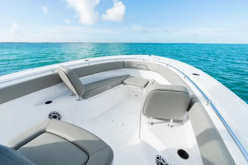 Slide: The Image of 2027 Sportsman Open 282 Center Console boat on clear blue water, featuring spacious seating. - 2