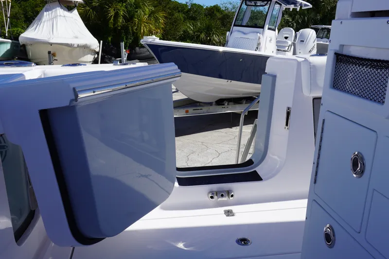 Slide: The Image of 2027 Sportsman Open 282 Center Console boat with open side door and sleek design. - 13