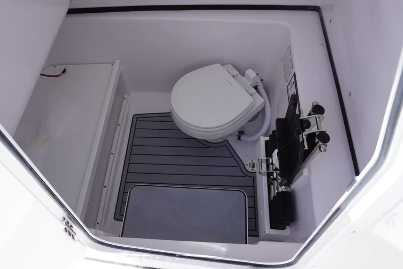 Slide: The Image of 2027 Sportsman Open 282 Center Console boat interior with compact marine toilet. - 33
