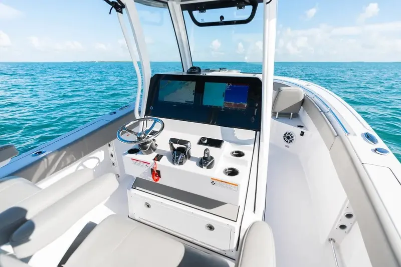 Slide: The Image of 2027 Sportsman Open 282 Center Console boat interior with steering wheel and navigation display. - 10