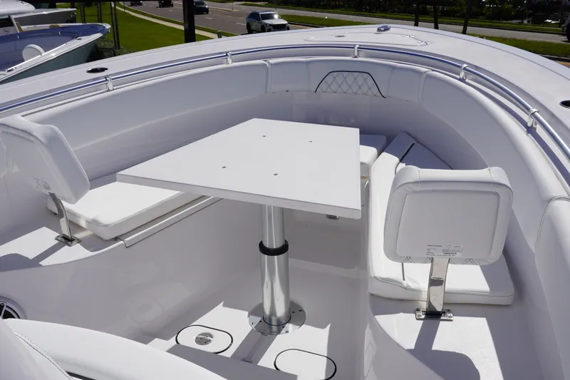 Slide: The Image of 2027 Sportsman Open 282 Center Console boat interior with seating and table. - 29