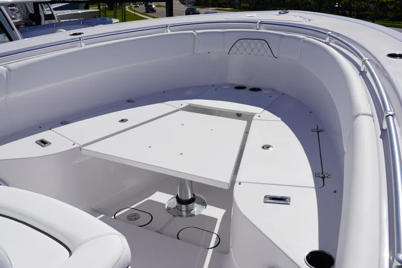 Slide: The Image of 2027 Sportsman Open 282 Center Console boat interior with seating and table. - 26