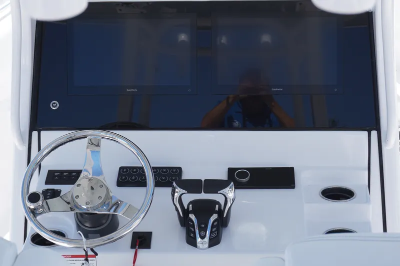 Slide: The Image of 2027 Sportsman Open 282 Center Console dashboard with dual Garmin displays and steering wheel. - 18