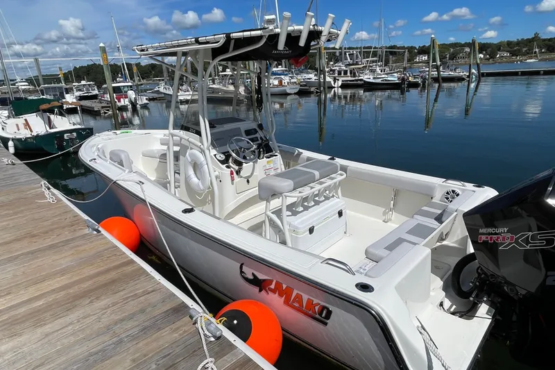 Slide: The Image of 2023 Mako 214 Center Console boat docked at marina with Mercury Pro XS engine. - 13