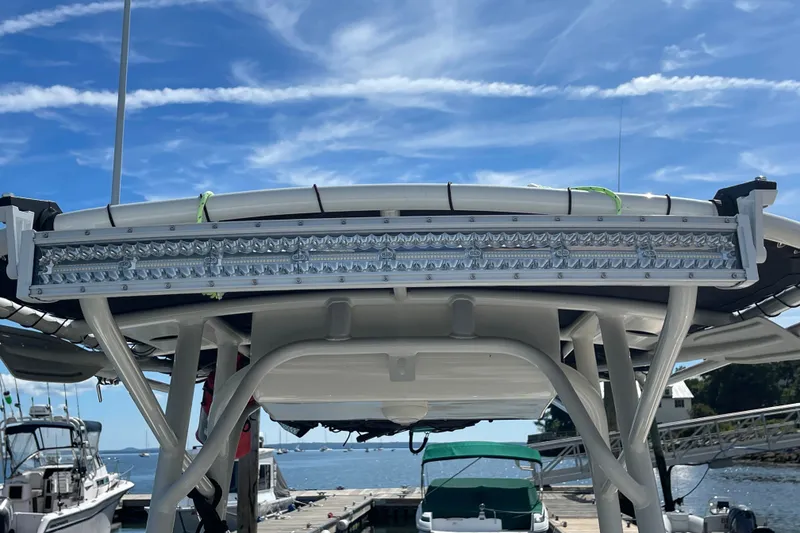 Slide: The Image of 2023 Mako 214 Center Console boat with LED light bar at marina. - 39