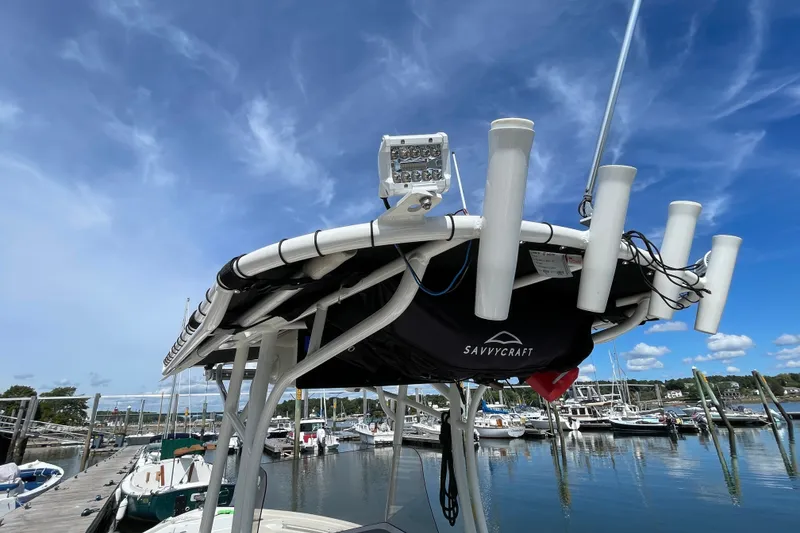 Slide: The Image of 2023 Mako 214 Center Console boat docked at marina under clear blue sky. - 44