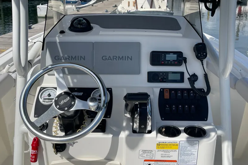 Slide: The Image of 2023 Mako 214 Center Console boat dashboard with Garmin navigation and communication equipment. - 26