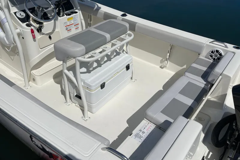 Slide: The Image of 2023 Mako 214 Center Console boat interior with seating and storage, featuring modern design. - 17