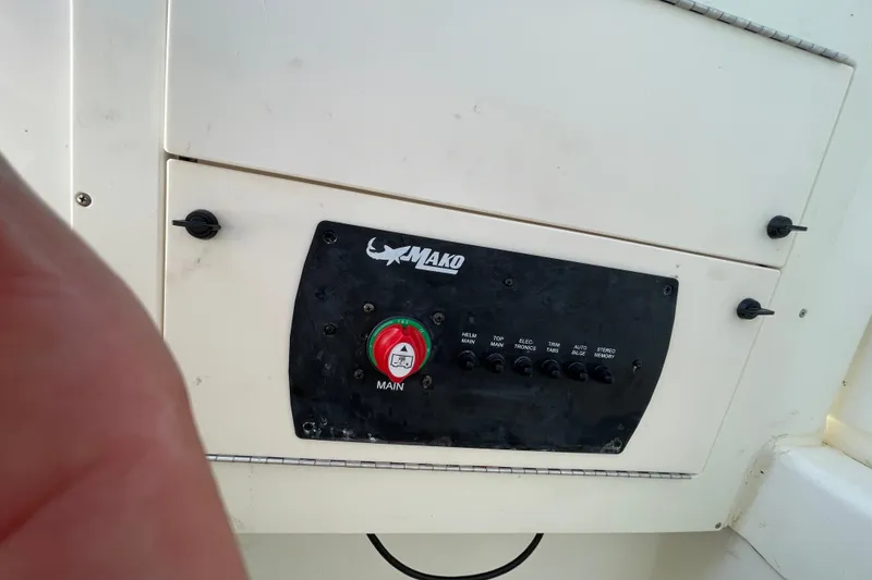 Slide: The Image of Control panel of 2023 Mako 214 Center Console boat with switches and main power button. - 34